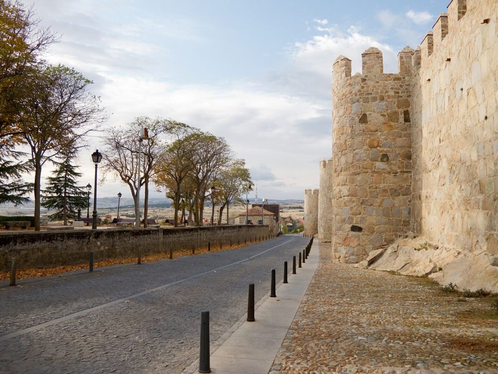 The medieval stone walls of Ávila glowing in evening light